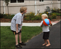 Two children playing with a beach-ball